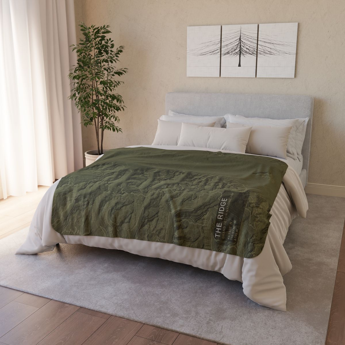 The Ridge Grand Teton topographic fleece blanket styled on a bed