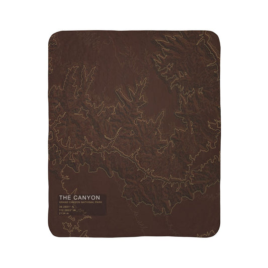 The Canyon Grand Canyon topographic fleece blanket shown flat in dark rust