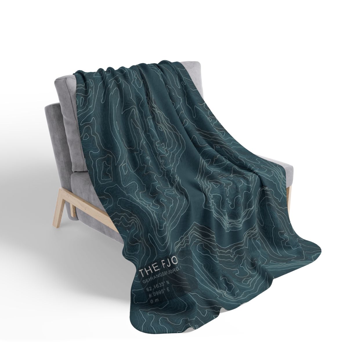 The Fjord blanket draped over a chair with gray fleece reverse visible