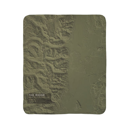 The Ridge Grand Teton topographic fleece blanket shown flat in olive green