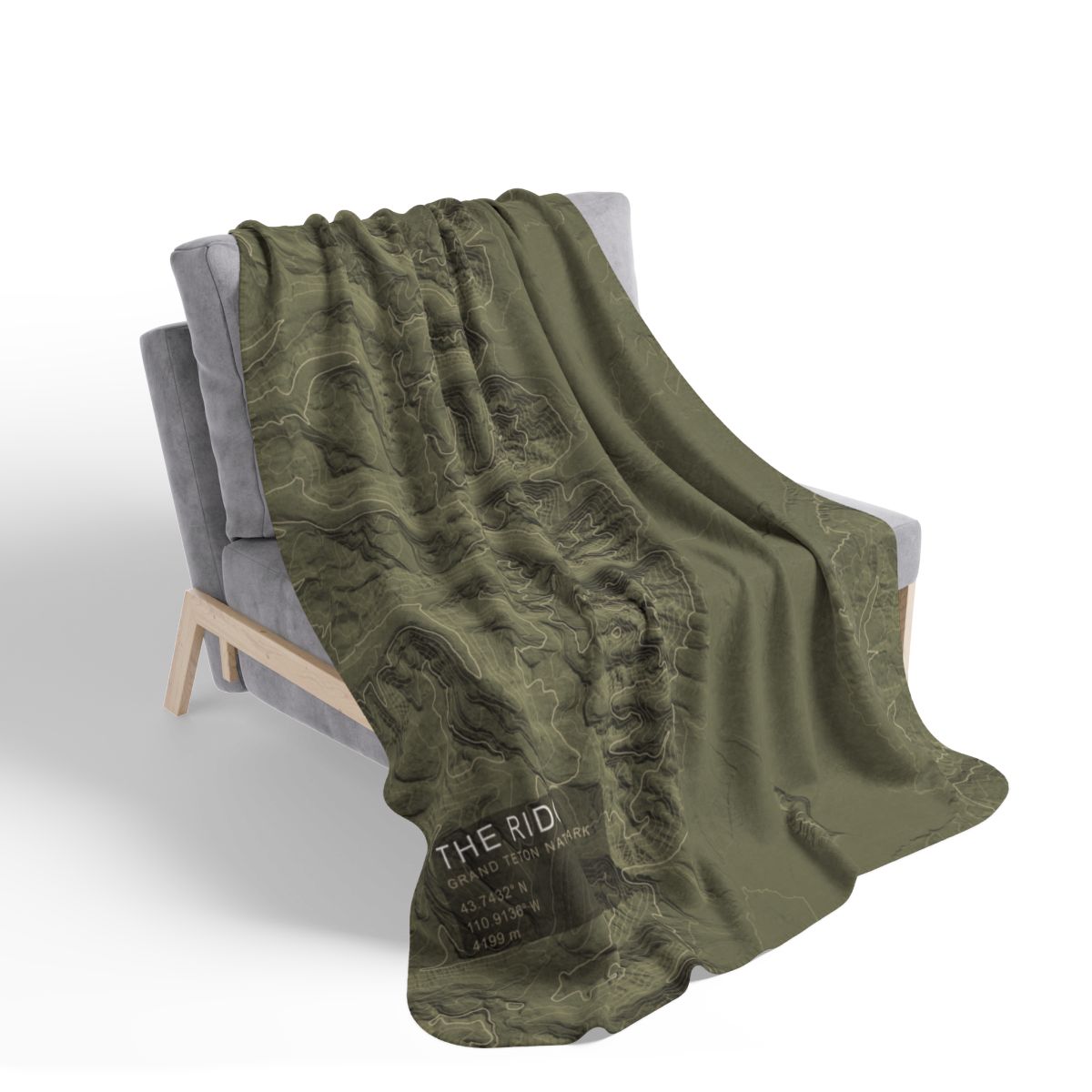 The Ridge blanket draped over a chair with gray fleece reverse visible