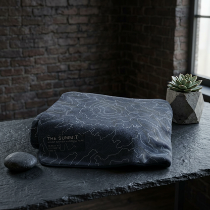 Folded The Summit Mount Rainier terrain blanket on a dark surface