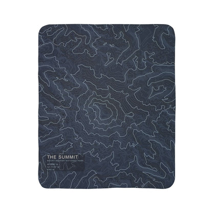 The Summit Mount Rainier topographic fleece blanket shown flat in navy