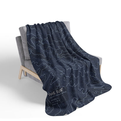 The Summit blanket draped over a chair with gray fleece reverse visible