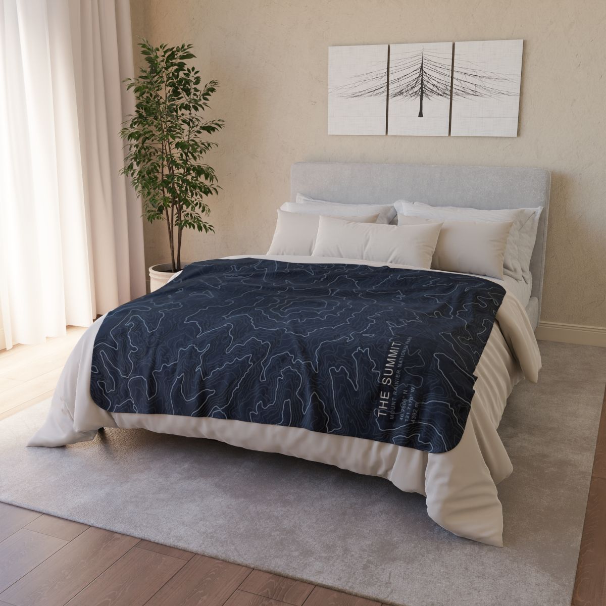 The Summit Mount Rainier fleece blanket styled on a bed