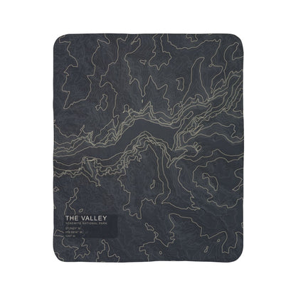 The Valley Yosemite topographic fleece blanket shown flat in dark slate