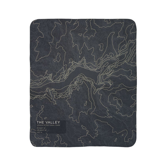 The Valley Yosemite topographic fleece blanket shown flat in dark slate